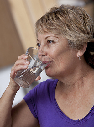 Woman drinking glass of water.